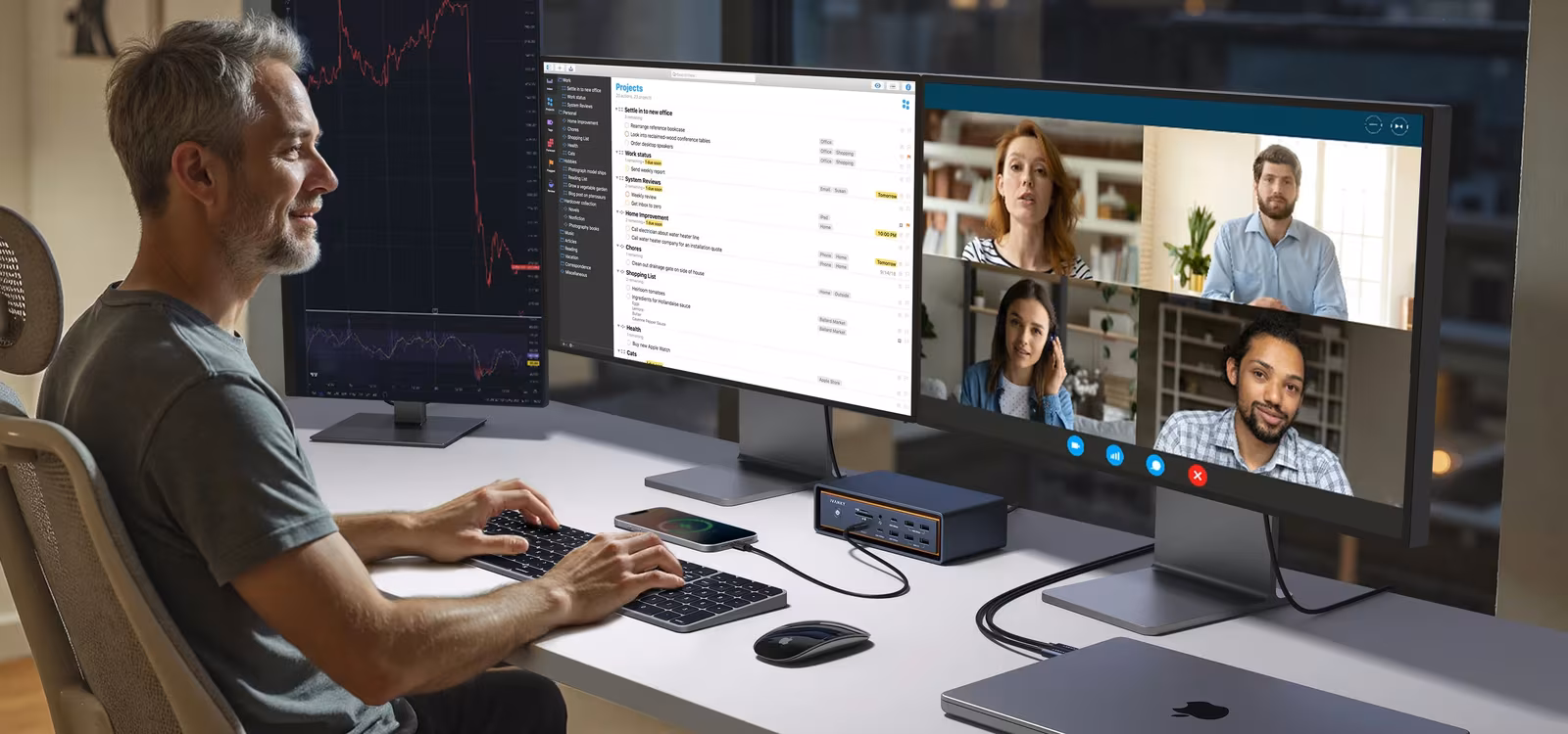 The FusionDock Max 2 on a home office desk with a MacBook and an external display